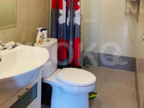 A bathroom with a toilet, sink, and shower.