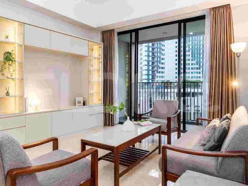 A modern living room with grey sofas, a marble-top coffee table, and a large balcony with city views.