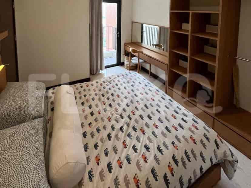 A bedroom with a bed, wardrobe, and vanity area.
