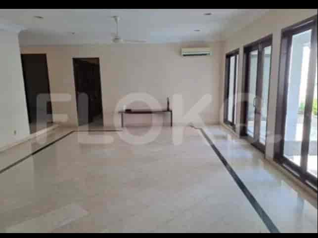 A spacious living room with marble flooring, large sliding doors, and a simple, elegant design.
