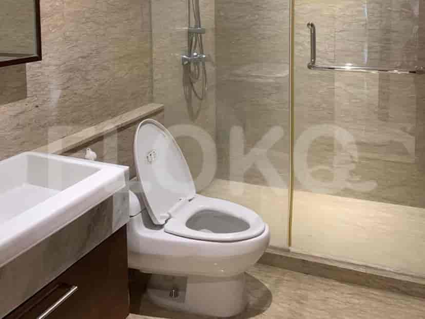 Modern bathroom with a toilet, shower, and vanity.