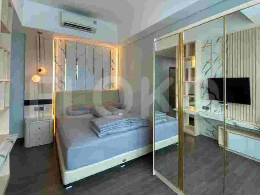 A bedroom with a queen-size bed, mirrored wardrobe, and modern lighting.