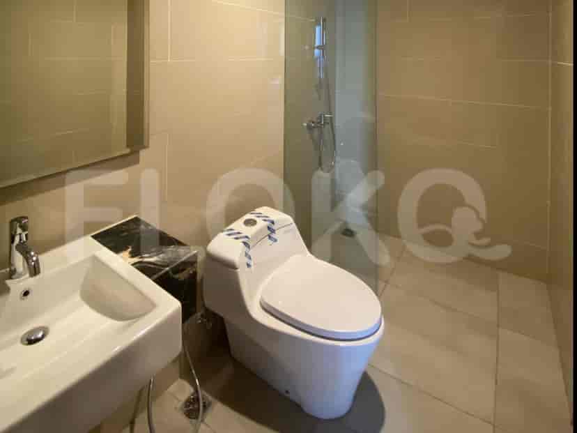 Modern bathroom featuring a walk-in shower, vanity with sink, and a toilet.