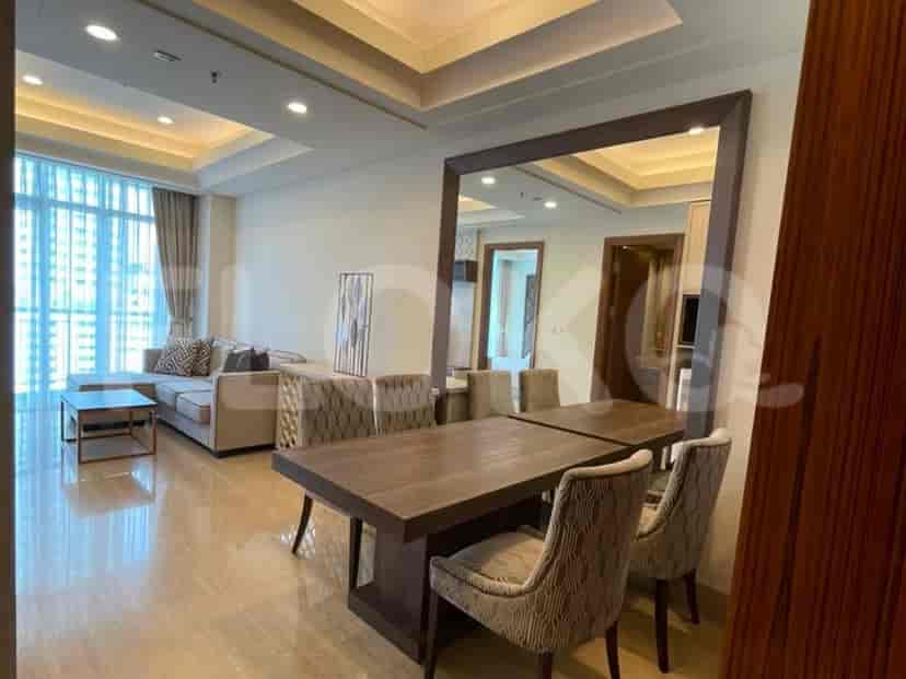 A dining area adjacent to the living room, with a large mirror reflecting the space.