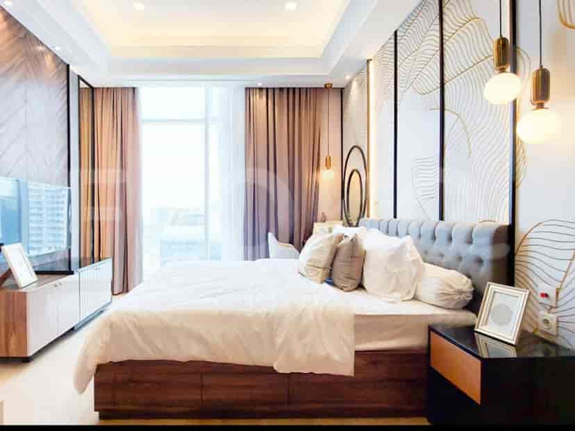 A modern bedroom featuring a king-sized bed, elegant wallpaper, and large windows.