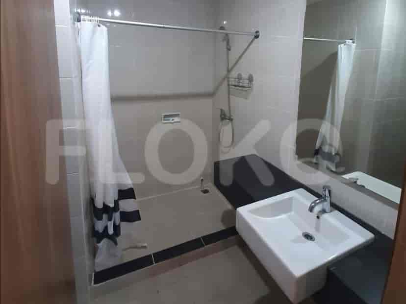 A bathroom with a sink, toilet, and shower area with a shower curtain.