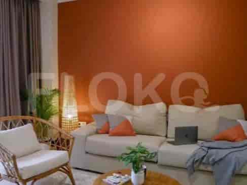 Living room with sofa, wooden chair, and decorative items.