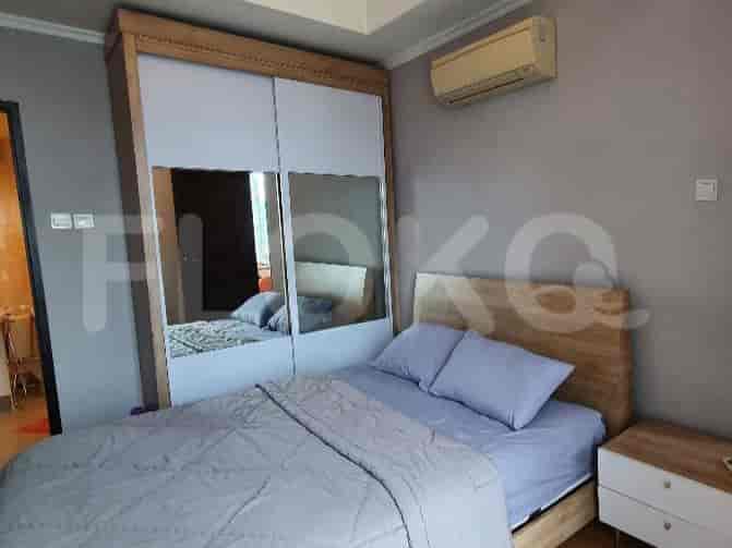 A bedroom featuring a double bed, sliding mirrored closet, and air conditioning.