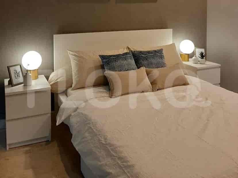 A master bedroom with a king-size bed, bedside tables with lamps, and a headboard.