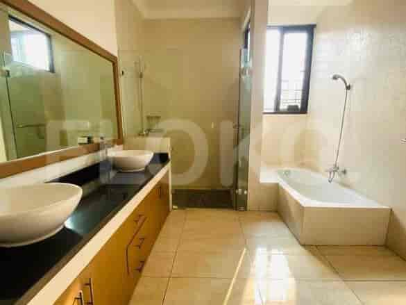 A master bathroom featuring a double vanity, a glass-enclosed shower, and a large bathtub with a view.