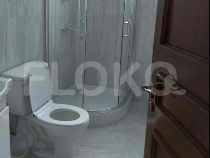 Bathroom with a glass-enclosed shower, toilet, and neutral color scheme.