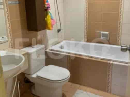 A bathroom with a bathtub, toilet, and sink.
