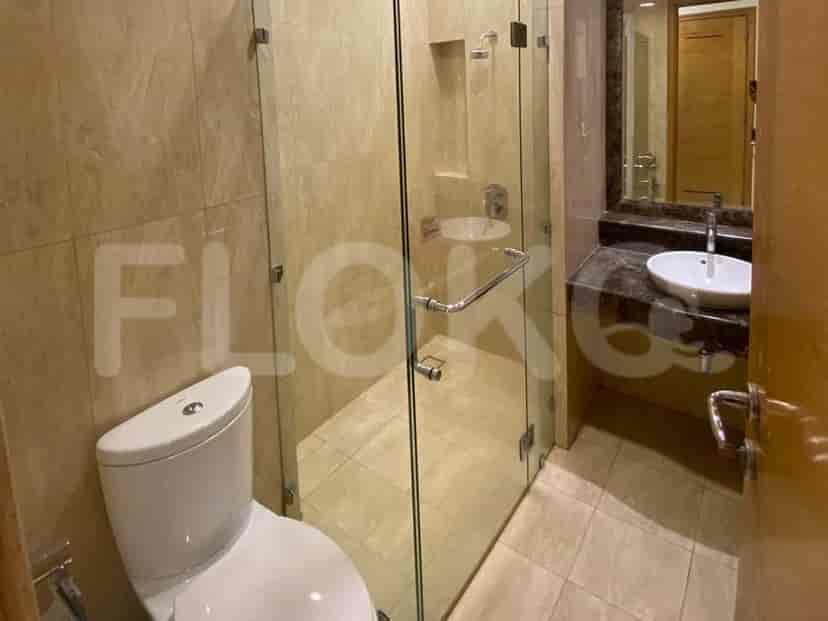 Bathroom with a toilet, shower, and sink.