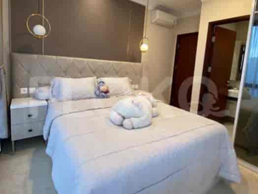 A master bedroom with a king-sized bed, nightstands, and a large closet.