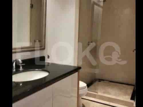A bathroom with a vanity, sink, mirror, and a glass-enclosed shower.