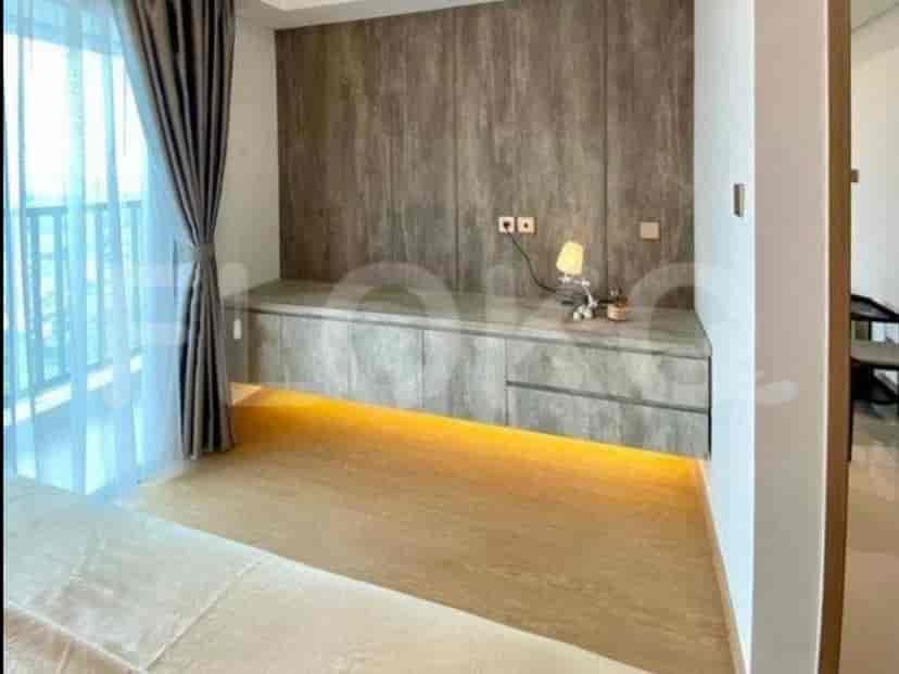 Cozy bedroom with a bed and a wooden accent wall.