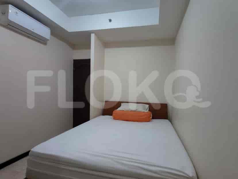 A bedroom with a queen-size bed and an air conditioning unit on the wall.