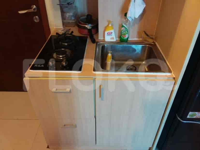 Close-up of the kitchen area with stove and sink.