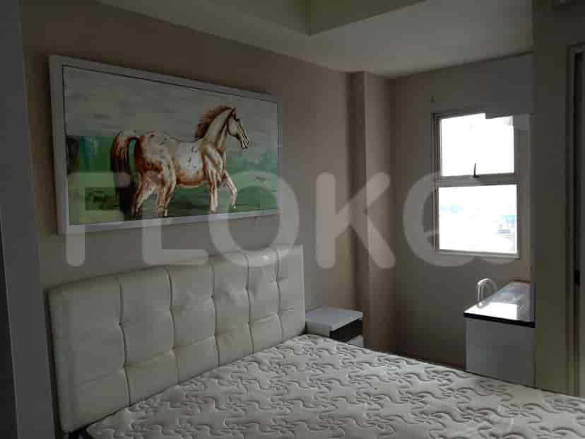 Bedroom with a bed, art, a bedside table, and a window with a view.