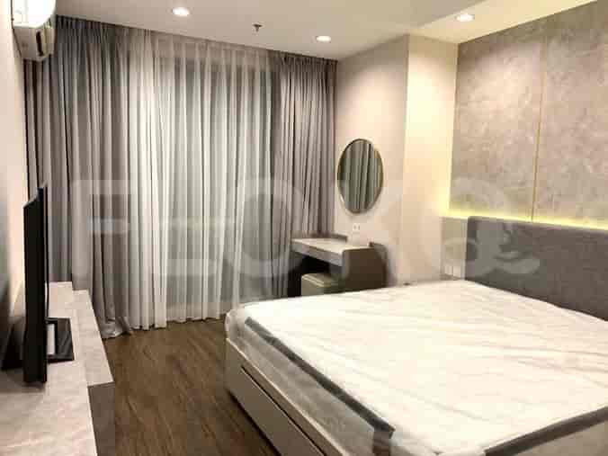 Another angle of the bedroom with a queen-sized bed, vanity area, and curtains.