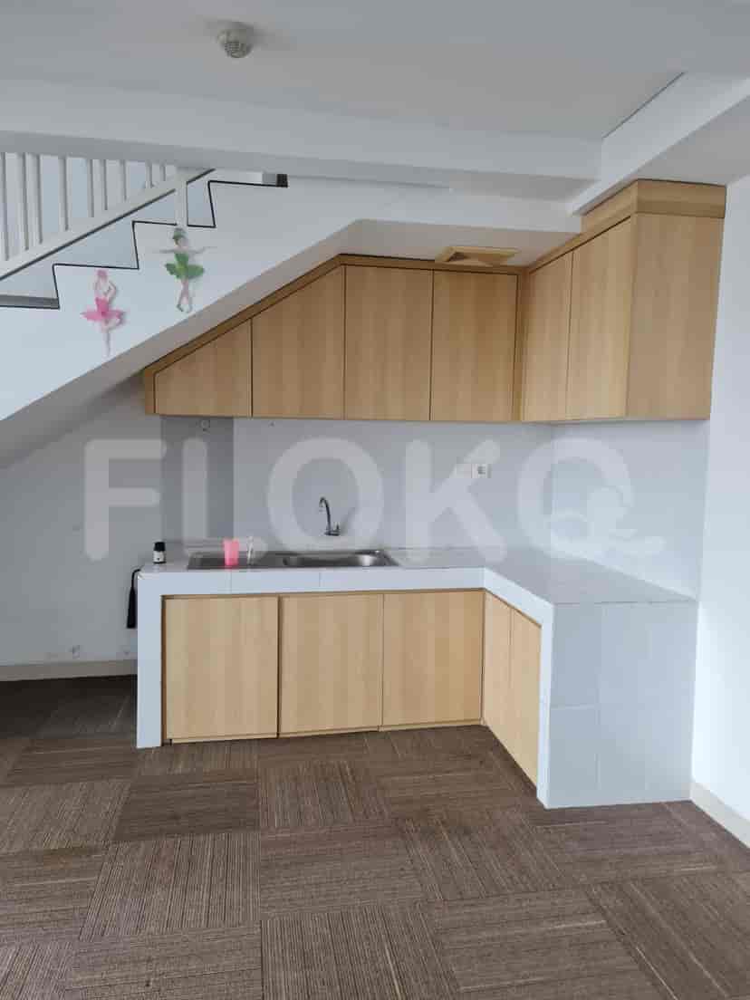 A small kitchen with wooden cabinets and a sink.