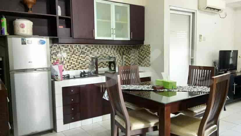 Kitchen with wooden cabinets, dining table and chairs.