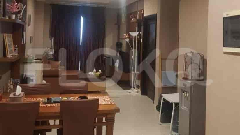 Dining area with a wooden dining table and living room with a sofa.