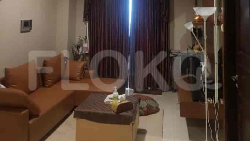 Living room with brown leather sofa, coffee table, and a floor lamp.