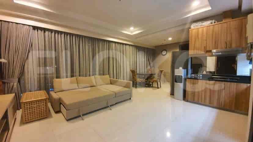 A modern living and dining area with a beige sectional sofa, wooden cabinets, and a dining set.