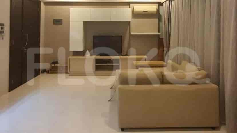 Living room with a light-colored sofa, TV console, and air conditioning unit.