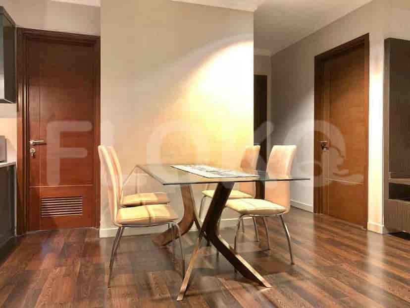 Dining area with glass table and chairs.