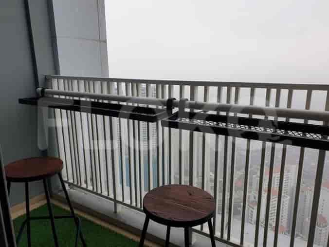 A balcony with a view of city skyline.