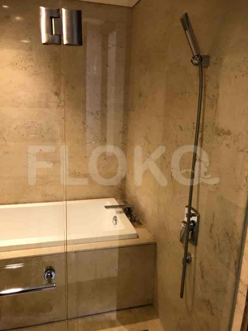 Modern bathroom featuring a shower with a rain shower head and a bathtub.