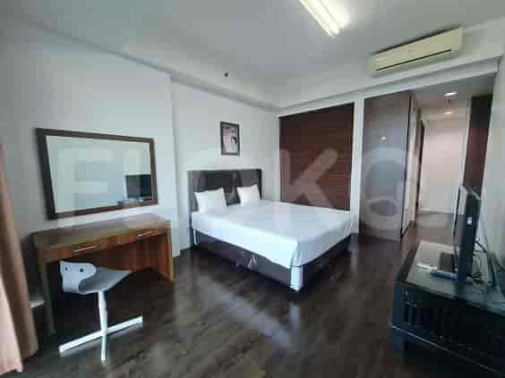 Spacious master bedroom with a king-size bed, desk, and a built-in closet.