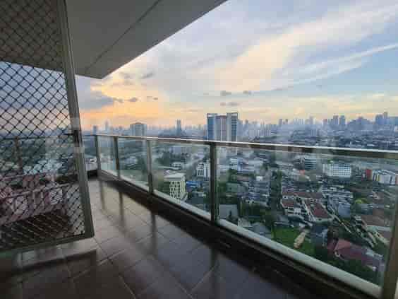 A balcony with a stunning panoramic city view.