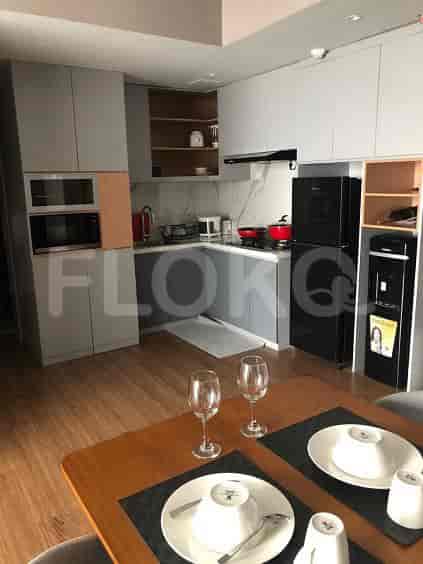 Modern kitchen with cabinets, appliances, and dining area.