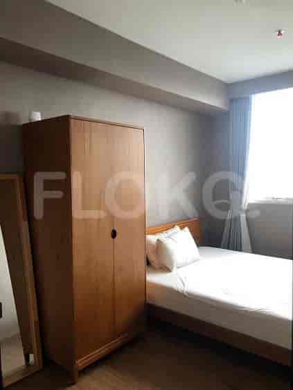 Bedroom with a wooden bed, wardrobe, and mirror.
