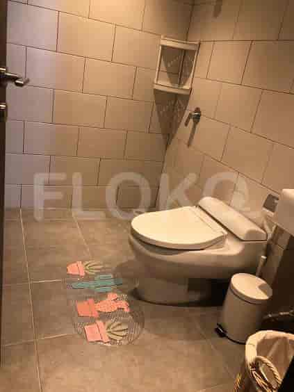 Bathroom with toilet, sink, and shower.