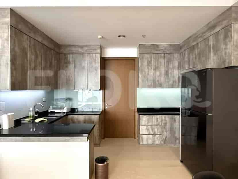 A modern open kitchen with grey cabinetry and black countertops.