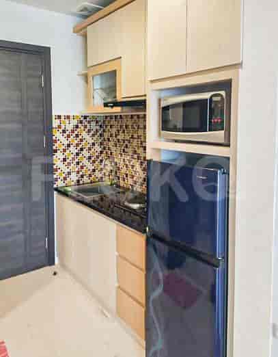 Modern kitchen with cabinets, microwave and a refrigerator.
