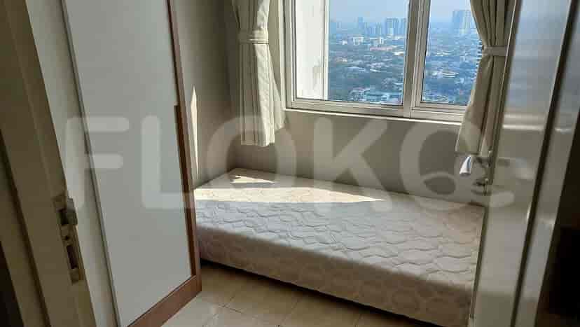 Bedroom with a bed and a view of city.