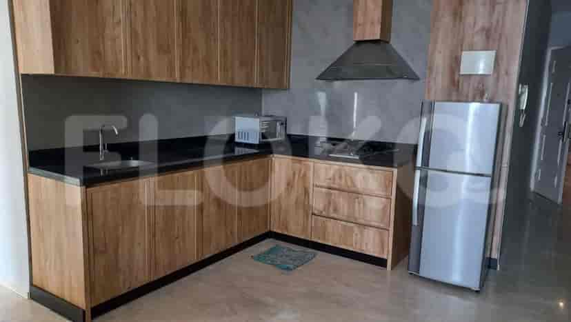 Kitchen with wooden cabinets and black countertop.