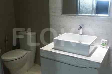 A bathroom featuring a sink and toilet.