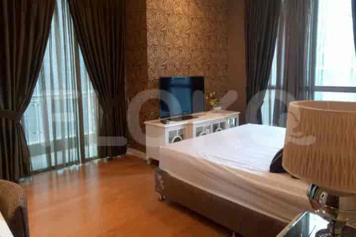 Master bedroom featuring a bed, tv, curtains, and wood flooring.