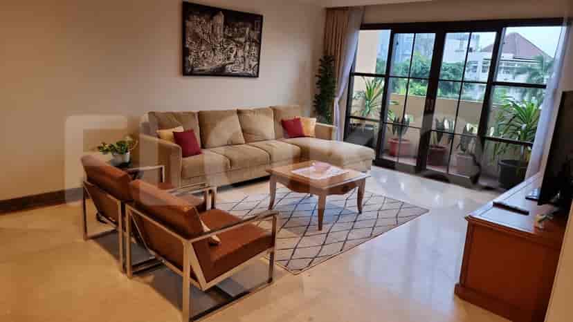 Living room with a sectional sofa, coffee table, two chairs, and access to a balcony.