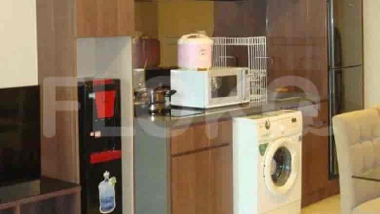 Kitchen with appliances including a microwave, washing machine, and water dispenser.