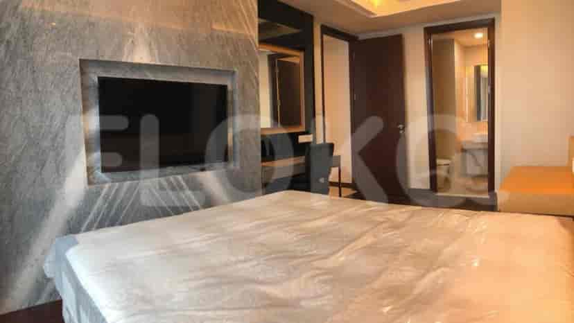 Bedroom featuring a king-size bed, a large TV, and a dressing table.