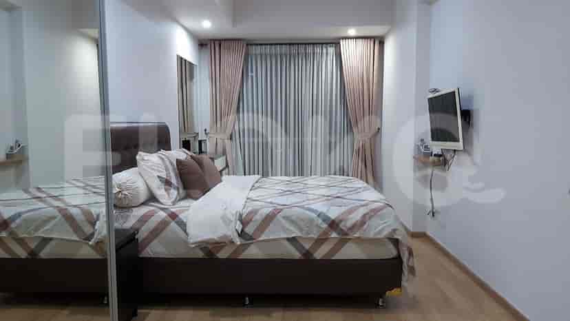 Another bedroom with a bed, nightstand, and window.