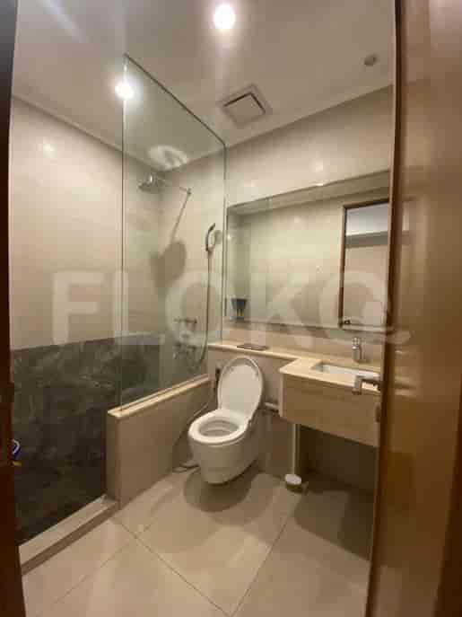 A bathroom featuring a toilet, sink, and shower.