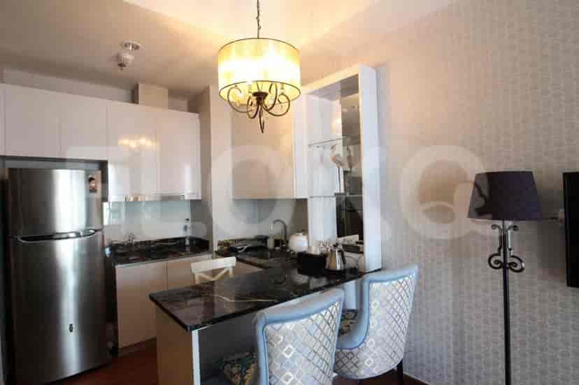 A kitchen area with a bar and modern appliances.